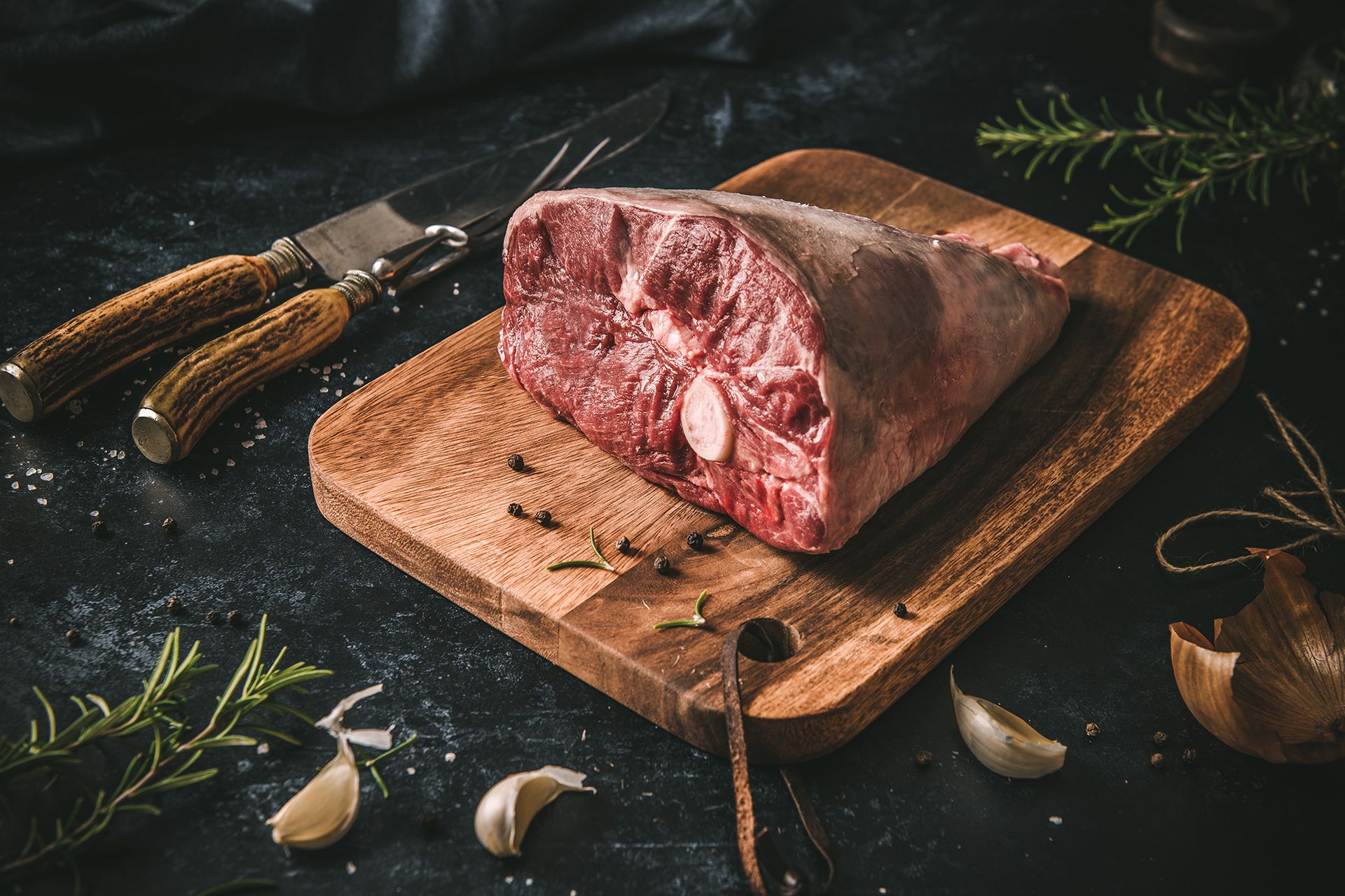 Quality British Lamb joint set on a chopping board. The image illustrates the quality and premium cuts available from Pickstock Foods